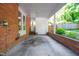 View of covered patio with brick wall and exterior closet at 903 W Maynard Ave, Durham, NC 27704