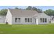 Spacious backyard features a manicured lawn, many windows, and a well-lit back door at 94 Mable Court # 16, Lillington, NC 27546