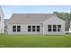 Bright back exterior features a large manicured lawn and multiple windows for abundant natural light at 94 Mable Court # 16, Lillington, NC 27546