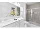 Bright bathroom featuring a double sink vanity and a glass-enclosed shower at 94 Mable Court # 16, Lillington, NC 27546