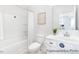 Clean, bright bathroom with white cabinets, a toilet, and a shower with white tiling at 94 Mable Court # 16, Lillington, NC 27546