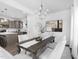 Dining room adjacent to the kitchen with table for six under an elegant chandelier at 94 Mable Court # 16, Lillington, NC 27546