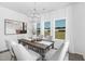 Elegant dining room with a modern chandelier and large windows overlooking the lush backyard at 94 Mable Court # 16, Lillington, NC 27546