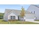 Single-Gathering home boasting a lush lawn, stone accents, and a convenient two-car garage at 94 Mable Court # 16, Lillington, NC 27546