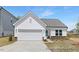 Charming single-story home with a white exterior, attached garage, and manicured front lawn at 94 Mable Court # 16, Lillington, NC 27546