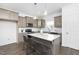 Stylish kitchen featuring an island, stainless steel appliances, and sleek quartz countertops at 94 Mable Court # 16, Lillington, NC 27546