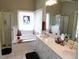 Large bathroom featuring a soaking tub, double sinks, and large windows at 100 Lager Ln, Garner, NC 27529