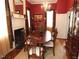 Formal dining room featuring a classic fireplace, chandelier, and wood floors at 100 Lager Ln, Garner, NC 27529