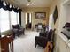Sunlit sitting room with comfortable armchairs and a guitar, ideal for relaxation at 100 Lager Ln, Garner, NC 27529