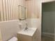 Bathroom with tiled walls, sink with faucet, toilet, and mirror at 1005 Driftwood Dr, Siler City, NC 27344