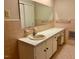 Neutral bathroom with large mirror, spacious white vanity, and coordinated peach tile at 1005 Driftwood Dr, Siler City, NC 27344