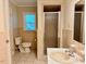 Tiled bathroom featuring a sink, shower, and toilet at 1005 Driftwood Dr, Siler City, NC 27344