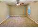 Large carpeted bedroom with ceiling fan and natural light at 1005 Driftwood Dr, Siler City, NC 27344
