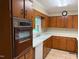 Kitchen featuring a window over the sink and wood cabinets at 1005 Driftwood Dr, Siler City, NC 27344