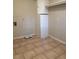 Well-lit laundry room with tiled floors, storage cabinets and overhead shelving at 1005 Driftwood Dr, Siler City, NC 27344