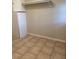 Tiled laundry room with a cabinet, overhead shelf and neutral paint at 1005 Driftwood Dr, Siler City, NC 27344