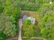 Birds eye view of a well manicured property with mature landscaping and a long drive way at 1016 Luminary Ln, Willow Springs, NC 27592