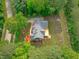 Aerial view showcasing the property's landscaped grounds, deck, and serene surroundings at 1016 Luminary Ln, Willow Springs, NC 27592