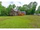 Wide backyard featuring a wooden deck, large grassy area, wood fence and mature trees at 1016 Luminary Ln, Willow Springs, NC 27592