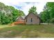 Spacious backyard featuring a wooden deck, lush lawn, and mature trees creating a private oasis at 1016 Luminary Ln, Willow Springs, NC 27592