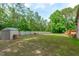 A backyard shed surrounded by mature trees at 1016 Luminary Ln, Willow Springs, NC 27592