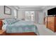 Tranquil bedroom with blue quilt, large windows, and access to the deck at 1016 Luminary Ln, Willow Springs, NC 27592