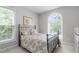Bright bedroom with patterned bedding, large window with a scenic view at 1016 Luminary Ln, Willow Springs, NC 27592