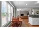 Bright dining area featuring wood table, rug, and open layout to the living room at 1016 Luminary Ln, Willow Springs, NC 27592