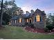 Charming exterior with manicured landscaping, enhanced by elegant outdoor lighting and a brick facade at 1016 Luminary Ln, Willow Springs, NC 27592