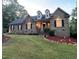 Charming brick home with dormers, manicured lawn, and landscape lighting at 1016 Luminary Ln, Willow Springs, NC 27592
