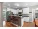 Well-lit kitchen with white cabinets and granite countertops at 1016 Luminary Ln, Willow Springs, NC 27592