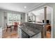 Open kitchen featuring granite countertops, a breakfast bar, and a view to the living room at 1016 Luminary Ln, Willow Springs, NC 27592