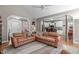 Open-concept living room with leather sofas and view to kitchen at 1016 Luminary Ln, Willow Springs, NC 27592