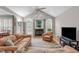 Bright living room with a vaulted ceiling, fireplace, and large windows at 1016 Luminary Ln, Willow Springs, NC 27592