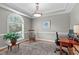 Well-lit home office featuring tray ceiling, arched window, and wood desk at 1016 Luminary Ln, Willow Springs, NC 27592