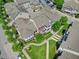 Aerial shot of townhouses with manicured lawns, walkways, and mature trees in a neighborhood setting at 10520 Sablewood Dr # 103, Raleigh, NC 27617