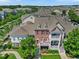 Aerial view of a townhouse complex with lush landscaping, patios, and architectural details at 10520 Sablewood Dr # 103, Raleigh, NC 27617