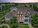 Aerial view of a townhouse complex with lush landscaping, patios, and architectural details at 10520 Sablewood Dr # 103, Raleigh, NC 27617