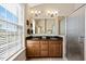 Bathroom showcasing a double vanity, granite countertop, tiled floor, and a glass-enclosed shower at 10520 Sablewood Dr # 103, Raleigh, NC 27617