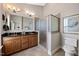 Bathroom with a double vanity, granite countertop, tiled floor, and a glass-enclosed shower at 10520 Sablewood Dr # 103, Raleigh, NC 27617