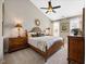 Bedroom featuring a ceiling fan, neutral walls, and carpet, with bedside tables for convenience at 10520 Sablewood Dr # 103, Raleigh, NC 27617