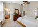 Bedroom showcasing a ceiling fan, neutral walls, and carpet, with ensuite access at 10520 Sablewood Dr # 103, Raleigh, NC 27617