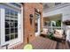 Cozy deck featuring two chairs, wood flooring, and brick exterior wall at 10520 Sablewood Dr # 103, Raleigh, NC 27617