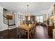 Open dining room featuring a chandelier, hardwood floors, and bar area at 10520 Sablewood Dr # 103, Raleigh, NC 27617