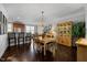 Elegant dining room featuring a chandelier, hardwood floors, and classic china cabinet at 10520 Sablewood Dr # 103, Raleigh, NC 27617