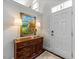 Welcoming entryway featuring hardwood floors, decorative artwork, and an elegant console table at 10520 Sablewood Dr # 103, Raleigh, NC 27617