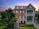 Multi-story townhouse with balconies, red shutters, landscaped front yard, and inviting entrance at 10520 Sablewood Dr # 103, Raleigh, NC 27617