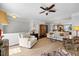 Bright and airy living room with comfortable seating, a ceiling fan, and hardwood floors at 10520 Sablewood Dr # 103, Raleigh, NC 27617
