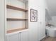 Open bathroom shelves provide storage and display space next to modern white cabinets at 107 Long Shadow Ln, Cary, NC 27518
