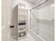Cozy bathroom showcasing subway tiles, a glass shower door, and functional shelving at 107 Long Shadow Ln, Cary, NC 27518